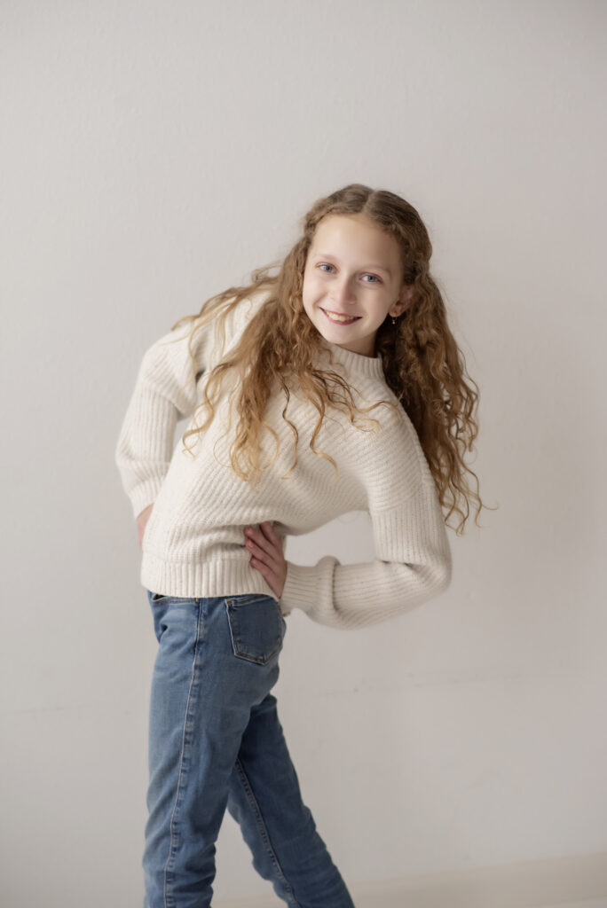 Portrait of young girl posing with her hand on her hip.