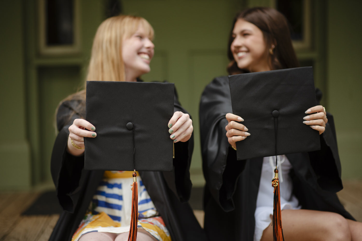 Best friends celebrate graduation together during photo session with Henwood Studios.