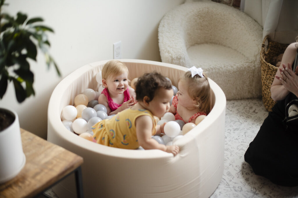 Little ones playing in a foam ball pit during birthday party.