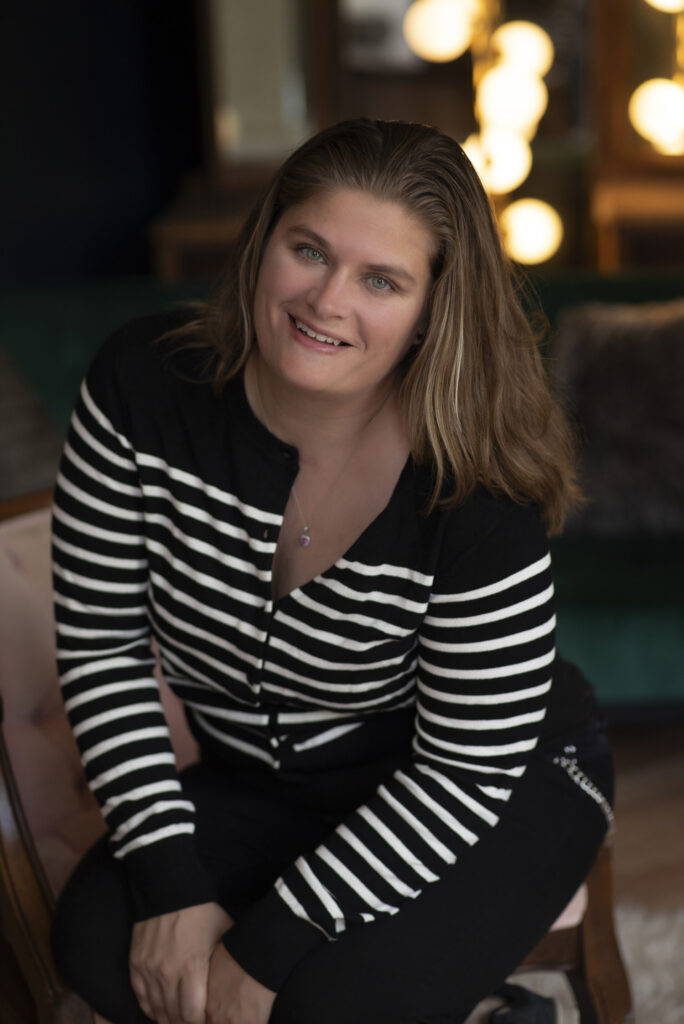 Portrait of woman smiling casually at the camera during professional headshot session.