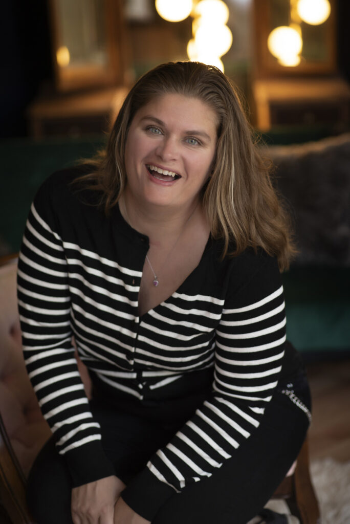 Playful headshot portrait of woman laughing.