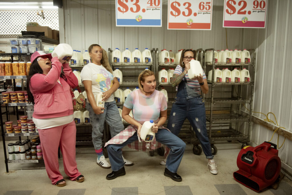 Goofy photo of four best friends posing in the dairy section of Horrocks Farm Market, taken by Henwood Studios.