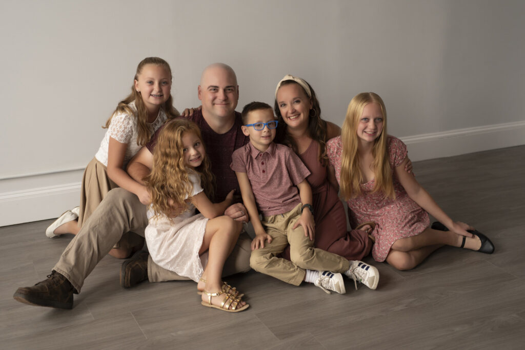 Candid photo of family in the studio for mini session with Henwood Studios.