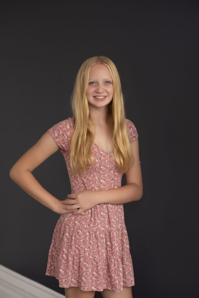 Portrait of oldest daughter smiling at the camera taken by Henwood Studios.