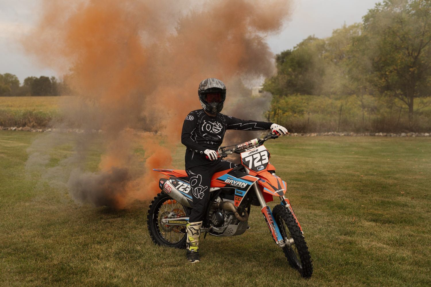 Portrait of high school senior on his dirt bike taken by Henwood Studios.