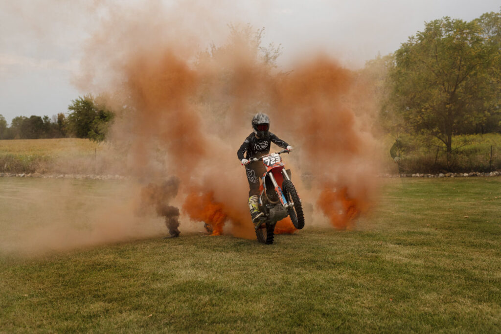 Action shot of senior riding his dirt bike taken by Henwood Studios.